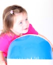 Toddler girl holding a beach ball Royalty Free Stock Photo