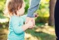 Toddler girl holding hands with her mother Royalty Free Stock Photo