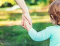 Toddler girl holding hands with her mother Royalty Free Stock Photo