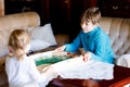 Toddler girl and kid boy playing table soccer with family at home. Smiling children, siblings play board football Royalty Free Stock Photo