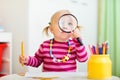 Toddler girl looking through magnifier Royalty Free Stock Photo