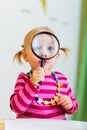 Toddler girl looking through magnifier Royalty Free Stock Photo