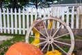 Toddler girl peeking through a wagon wheel on a fall day Royalty Free Stock Photo