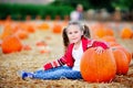 Toddler girl picking a pumpkin for Halloween