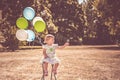 Toddler girl playing with balloons and bubbles Royalty Free Stock Photo