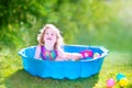 Toddler girl playing with balls in the garden