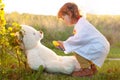 Toddler girl playing doctor with teddy bear putdoors