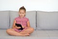 Toddler girl playing games on her tablet