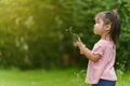 Toddler girl playing grass flower in field