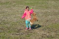 Toddler girl playing with her dog Royalty Free Stock Photo