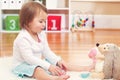 Toddler girl playing with her stuffed animals Royalty Free Stock Photo