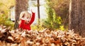 Toddler girl playing outside in fall leaves Royalty Free Stock Photo