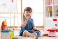 Toddler girl playing toy kitchen Royalty Free Stock Photo