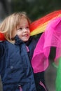 Toddler girl plays with silk scarfs