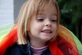 Toddler girl plays with silk scarfs Royalty Free Stock Photo