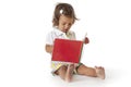 Toddler girl pretends to read a book Royalty Free Stock Photo