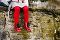 Toddler girl in red shoes and pantihose stockings. Child with backpack to nursery or playschool. Stylish and beautiful Royalty Free Stock Photo