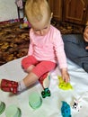 Toddler girl sculpt with plasticine at home