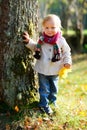 Toddler girl standing near tree Royalty Free Stock Photo