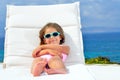 Toddler girl on sunbed