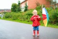 Toddler girl with umbrella outside on rainy day Royalty Free Stock Photo