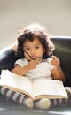 Toddler, glasses or book read fun education, learning or childhood development knowledge. Little girl, sofa or story Royalty Free Stock Photo