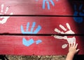 Toddler Hand on Paint Hands