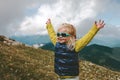 Toddler happy raised hands hiking in mountains family travel vacations healthy lifestyle Royalty Free Stock Photo