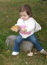 Toddler holding a big leaf she found Royalty Free Stock Photo