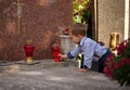 Toddler holding a candle on the grave