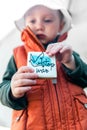 Toddler holding cookies with the words `Stop War` Royalty Free Stock Photo