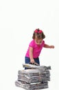 Toddler holding a stack of paper ready for recycli