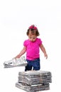 Toddler holding a stack of paper ready for recycli