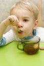 Toddler holding teaspoon in his mouth