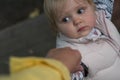 Toddler holds mom`s hand and looks at her, close-up. Little cute girl holds the hand of an adult on a walk. joint walks with the Royalty Free Stock Photo