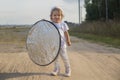 A toddler holds a reflector for the photographer. little helper assistant Royalty Free Stock Photo