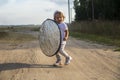 A toddler holds a reflector for the photographer. little helper assistant Royalty Free Stock Photo