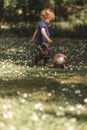 Toddler kicking the ball Royalty Free Stock Photo