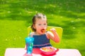 Toddler kid girl eating macaroni tomato pasta