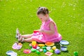 Toddler kid girl playing with food toys sitting in turf Royalty Free Stock Photo