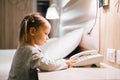 toddler kid in hotel room looking at old phone