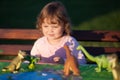 Toddler kid playing with a toy dinosaur. Royalty Free Stock Photo