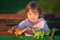 Toddler kid playing with a toy dinosaur. Royalty Free Stock Photo
