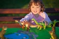 Toddler kid playing with a toy dinosaur. Royalty Free Stock Photo