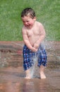 Toddler laughing in a summer fountain Royalty Free Stock Photo