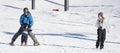 Toddler Learns to Ski with Dad While Watches & Mom Takes Photos. Royalty Free Stock Photo