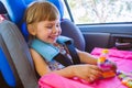 Toddler little girl playing in the car seat Royalty Free Stock Photo