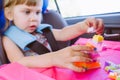 Toddler little girl playing with constructor in the car seat Royalty Free Stock Photo