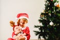 Toddler and newborn baby, siblings disguised as christmas, holiday concept
