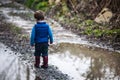 Toddler outdoors beside large puddle Royalty Free Stock Photo